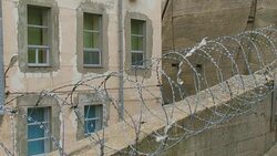secret facility behind a concrete wall and barbed wire Stock Footage