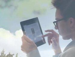 Young man with glasses using digital tablet, cloud reflections. Stock Footage
