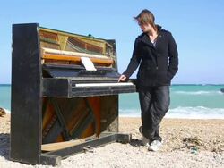 thoughtful young woman playing on an old piano Stock Footage