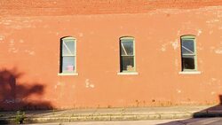 MS Female athlete running on urban street at sunrise Stock Footage