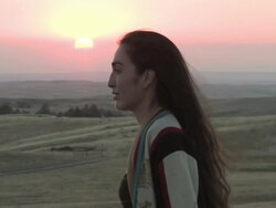 CU ZO American Indian young woman standing on great plains at sunset time / Pine Ridge, South Dakota, United States    Stock Footage