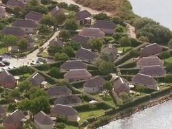 MS AERIAL Shot of Holiday complex behind Port Barcares (for red roofs) / Languedoc Roussillon, France Stock Footage