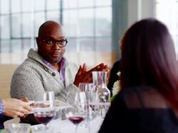 MS smiling mature man sitting at table with friends during dinner party Stock Footage
