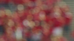 Out of focus background shot of spectators in a football stadium, camera pans right. Stock Footage