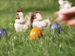 Woman hand putting Easter eggs on the grass Stock Footage