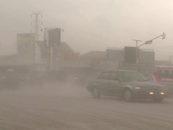 Traffic drives on intersection coated in thick layer of volcanic ash after eruption of Merapi volcano; Central Java, Indonesia. 30 October 2010 / AUDIO Stock Footage