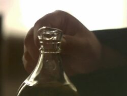 Close Up pan-right tilt-down tilt-up - A hand pours oil from a carafe onto a garden salad. / Greece Stock Footage