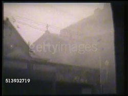 1946: HURRICANES:  WS Two 'Blue Peter' maritime flags flapping in strong wind. VS Hurricane winds blowing through coastal town, flooding & strong winds. VS Large floods flowing through another town, some stranded victims. Natural disasters, tsunami Instructional Video
