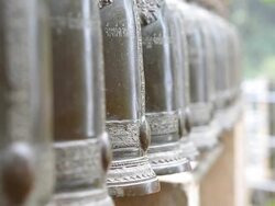 people walk along and beat bells of temple Stock Footage