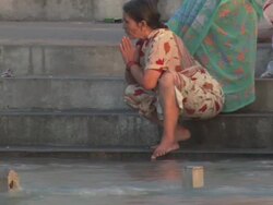 TU A woman sending a candle afloat down the Ganges and praying / Kashi, Uttar Pradesh, India Stock Footage