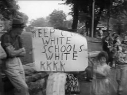 B/W 1950s PAN female pro-segregation protestor with sign - "Keep our white schools white - KKKK" Stock Footage