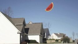 Slow Motion of Tossing Fruit Watermelon into Sky With Homes Behind Stock Footage