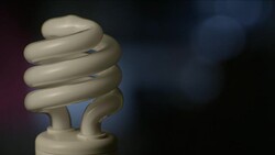 Man's fingers twist a CFL light bulb in the socket, struggling to keep it on. Stock Footage