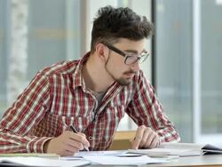 MS Male Student Writing An Assignment Stock Footage