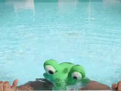 Swimmer in a Frog Costume Pop Out from the Water Stock Footage