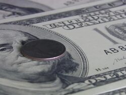 Quarter coin spinning over hundred dollars bill. Currency. Finance. Money. Stock Footage
