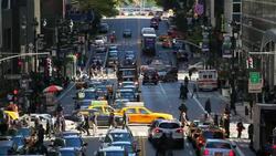 Traffic and pedestrians move through a busy intersection on 42nd Street in Mid Town Manhattan, New York. Stock Footage