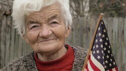 Senior Woman Holding USA Flag Looking at Camera and Smiling Stock Footage