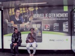 MS Three people waiting for trolley at bus stop / Amsterdam, Netherlands Stock Footage