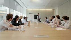 Businessman at flipchart leading meeting in conference room Stock Footage