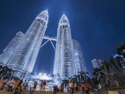WS LA T/L Petronas Towers at dusk with tourists / Kuala Lumpur, Selangor, Malaysia Stock Footage