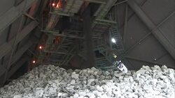 Dirt rains down from a machine onto a pile of rocks Stock Footage