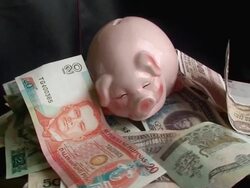 Piggy bank and foreign currency Stock Footage