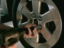 CU Mechanic removing lugnuts from wheel / Tampa, Florida, USA Stock Footage