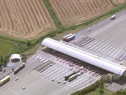 WS AERIAL View of toll plaza with farm field area near Aigues Mortes city / Languedoc Roussillon, France Stock Footage