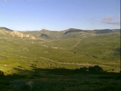 WA Pan right, across grassy/rocky valley in Australian alpine region Stock Footage