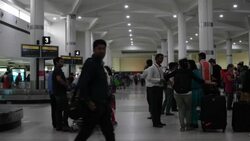 Passengers waiting at the luggage belts at the domestic airport in Delhi Stock Footage