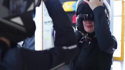 young blonde measures the biker clothes before the mirror Stock Footage