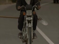 Man riding old Honda motorbike with Shovel tied to the back, Maraghah, Iran (sound available) Stock Footage