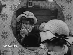 1953: THREE YEAR OLD: Girl in hat standing in front of mirror looking at mother's make-up, powder compact, smiling REVEALS lipstick covered lips, holding powder puff.   [SOT Dr. Spock talking about 'identifying', imitation due to admiration]... Instructional Video