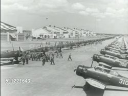 MOT 1939: PRIVATE AVIATION SCHOOL: US ARMY AIR CORPS TRAINING: HA WS Group of young adult men in pilot uniforms, goggles on top of head. POV Behind pilots sanding around instructor at blackboard w/ diagram. Instructional Video