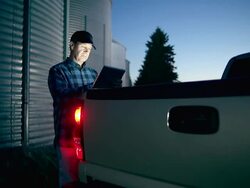 Farmer uses a digital tablet to access the internet Stock Footage