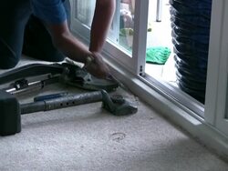 Laying Carpet, Using Chisel to Stretch Rug into Corner Stock Footage