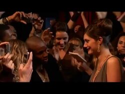 Medium shot female celebrity meeting fans and signing autographs on red carpet/ London, England Stock Footage