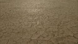 Cracked, dry mud characterizes a flat lake bed. Stock Footage