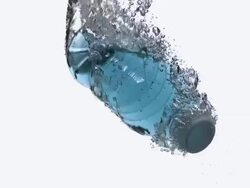 CU SLO MO Shot of Plastic Bottle of Water falling and Splashing against White Background / Calvados, Normandy, France Stock Footage