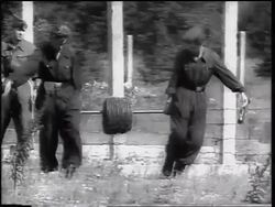 B/W 1961 soldiers unrolling barbed wire in construction of Berlin Wall / Germany / Europe Stock Footage