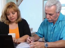 Latin Couple Work on Home Finances with Laptop- WS Stock Footage