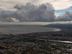 AERIAL over cityscape with low clouds and Mediterranean horizon/ Nice, France Stock Footage