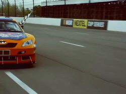 TS WS PAN ZI CU Racecar driver holding checkered flag out car window while driving on racetrack / Long Pond, Pennsylvania, USA Stock Footage