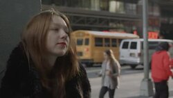 Young woman wrap herself up into coat and goes away Stock Footage