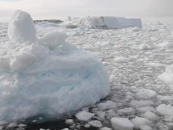 MS Shot of Iceberg with small chunks of ice floating / Ilulissat, Northern Greenland, Greenland Stock Footage