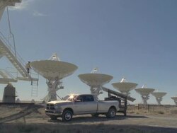 WS Satellite dishes in front of truck with man descending on steps / San Augustine, New Mexico, USA  Stock Footage