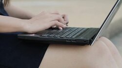 girl typing on laptop outdoor scene Stock Footage