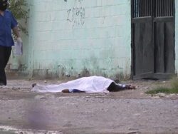 MS Shot of Dead gun shot victim on ground AUDIO / Ciudad Juarez, Juarez, Mexico Stock Footage