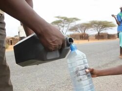 Young boy has his water bottled filled Stock Footage